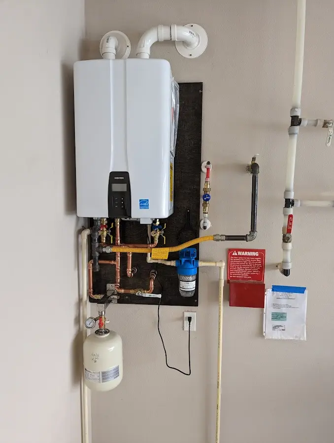 Professional plumber installing copper piping in a Kalaeloa home